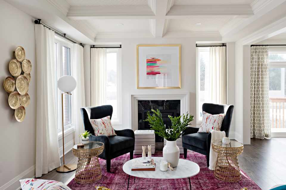 designer formal sitting room with reddish, pink accents and gold metal decor